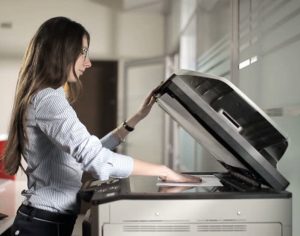 woman using a Ricoh Copy Machine